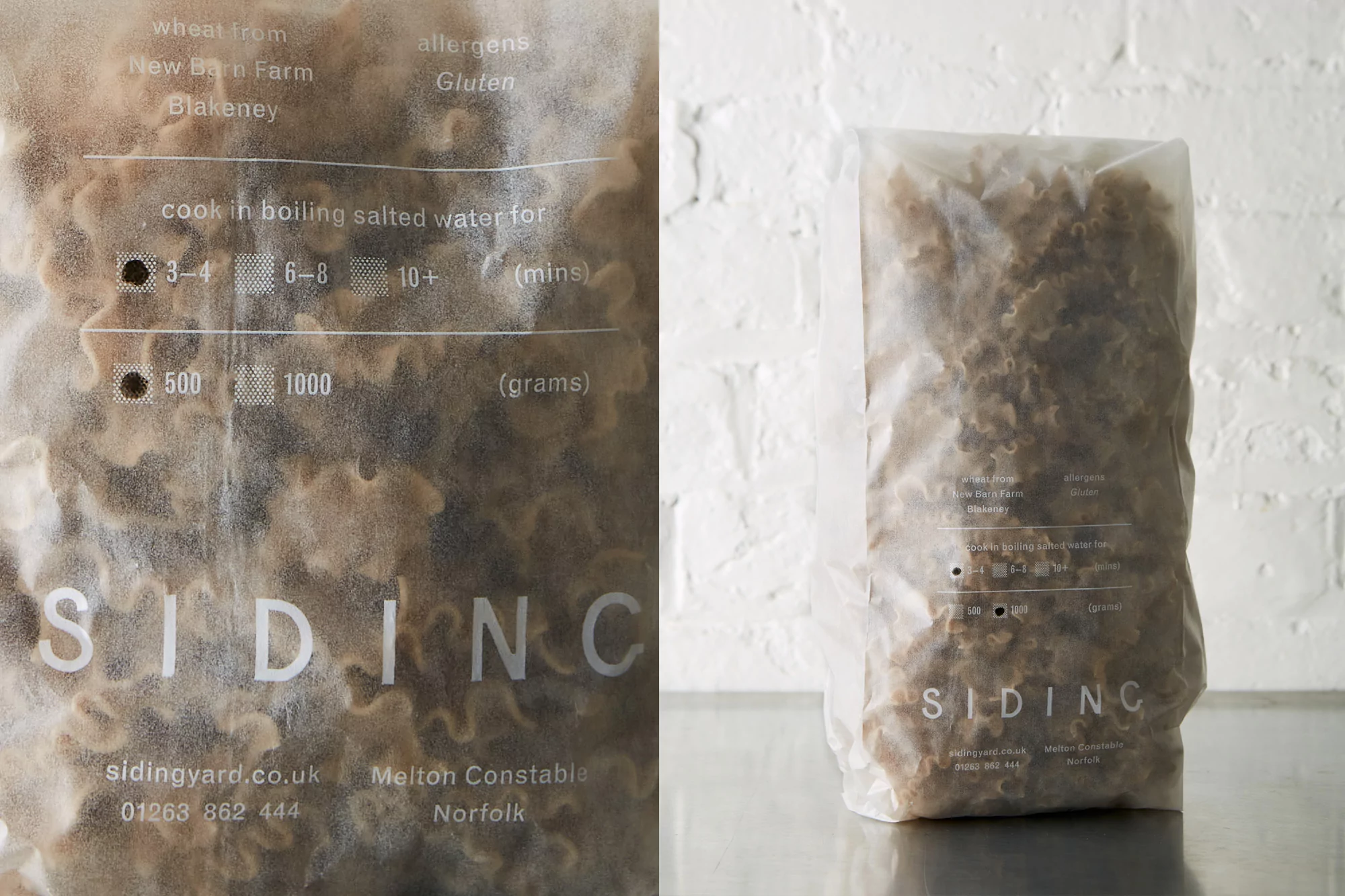 Close-up of two translucent bags filled with uncooked pasta twists, with printed brand and cooking instructions, on a metallic surface.