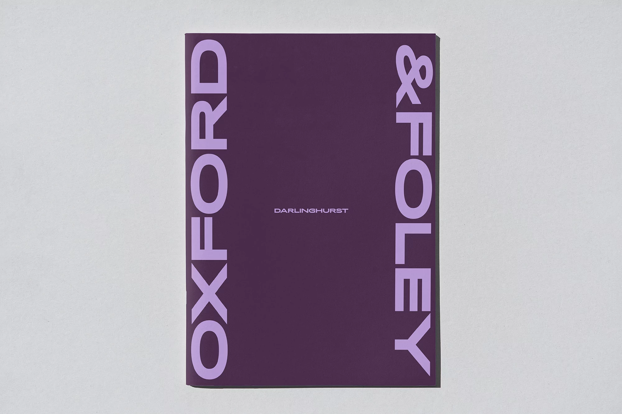 A book cover in a vertical format featuring a minimalist design with a plum background and lilac-colored large sans-serif typography.