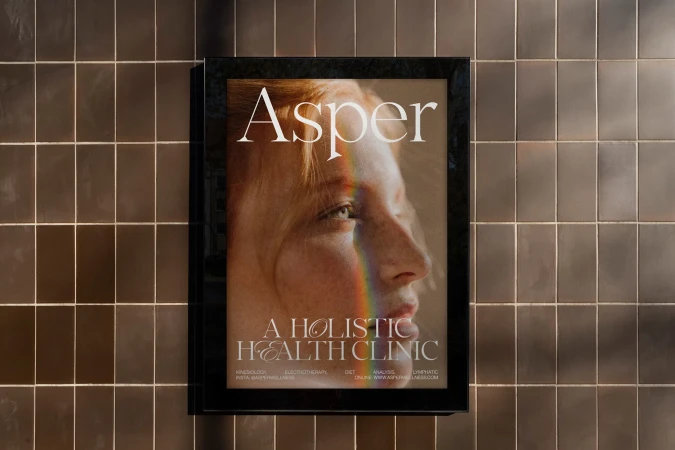 Poster on a tiled wall featuring a side-profile portrait of a fair-skinned woman with red hair and a rainbow of light across her face.