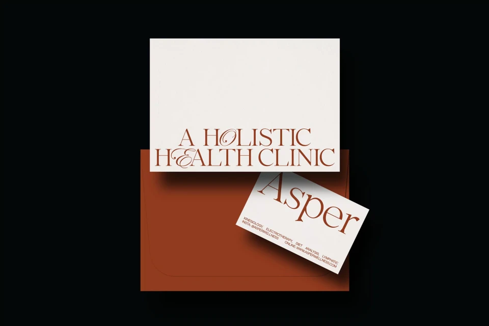 Promotional image featuring business cards and stationery for A Holistic Health Clinic, presented in a minimalist style with a brown and off-white color scheme.