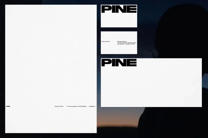 Brand identity stationery suite for PINE featuring minimalist black typography on white paper against a dusk landscape