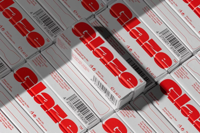 An overhead arrangement of white product packaging boxes featuring bold red Glaze typography and barcodes.