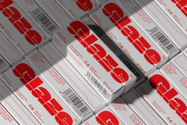 An overhead arrangement of white product packaging boxes featuring bold red Glaze typography and barcodes.