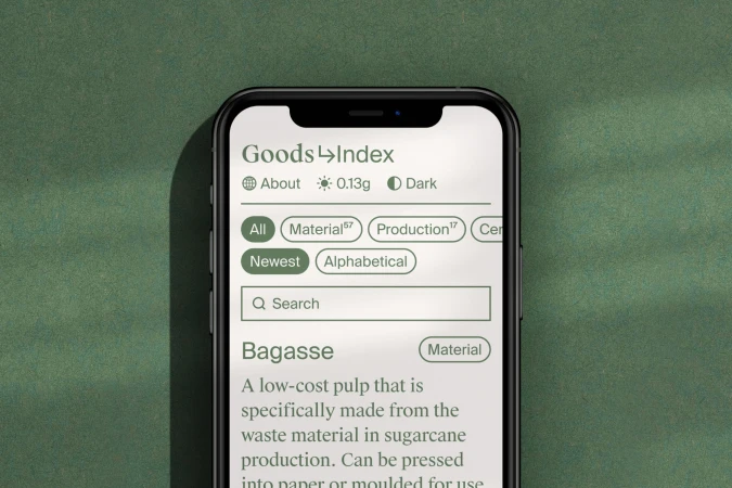 Goods Index application interface displayed on a smartphone screen, featuring a search bar and material information, on a green background.
