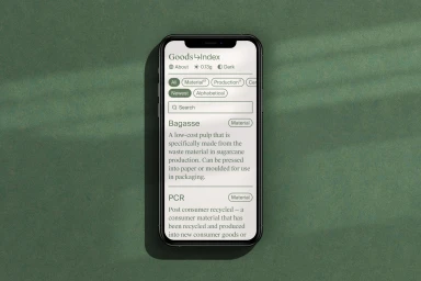 A black smartphone displaying a resource interface against a textured green background with natural window light shadows.