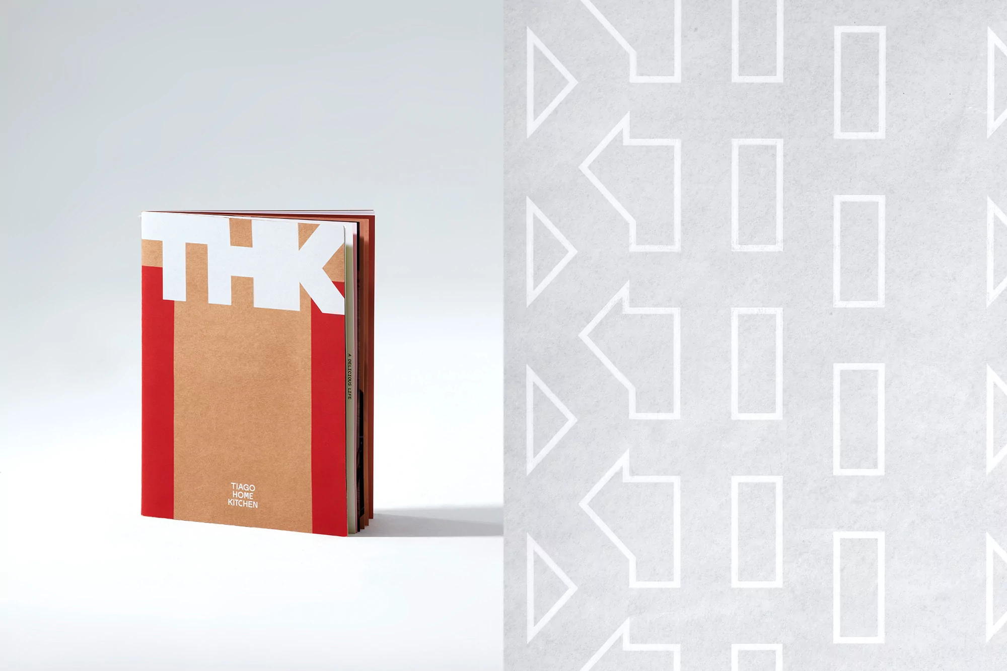 Tan and red 'THK' book cover with white lettering displayed on a white surface next to a pattern of white arrows and rectangles.