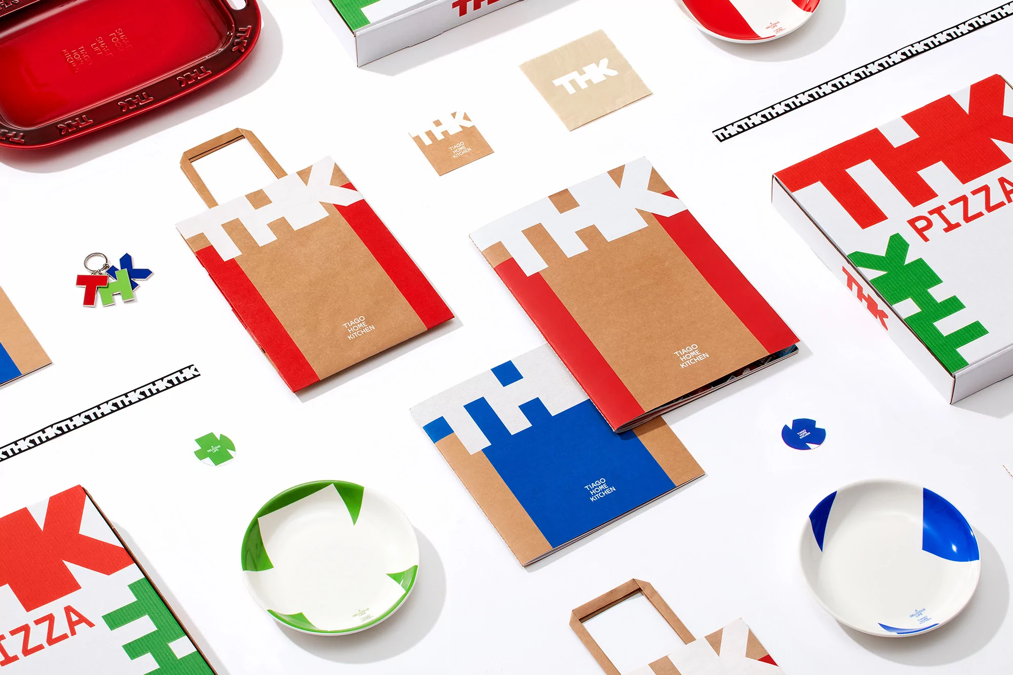 Graphic design featuring packaging, including pizza boxes, plates, and bags with a cohesive THK logo and branding on a white surface.