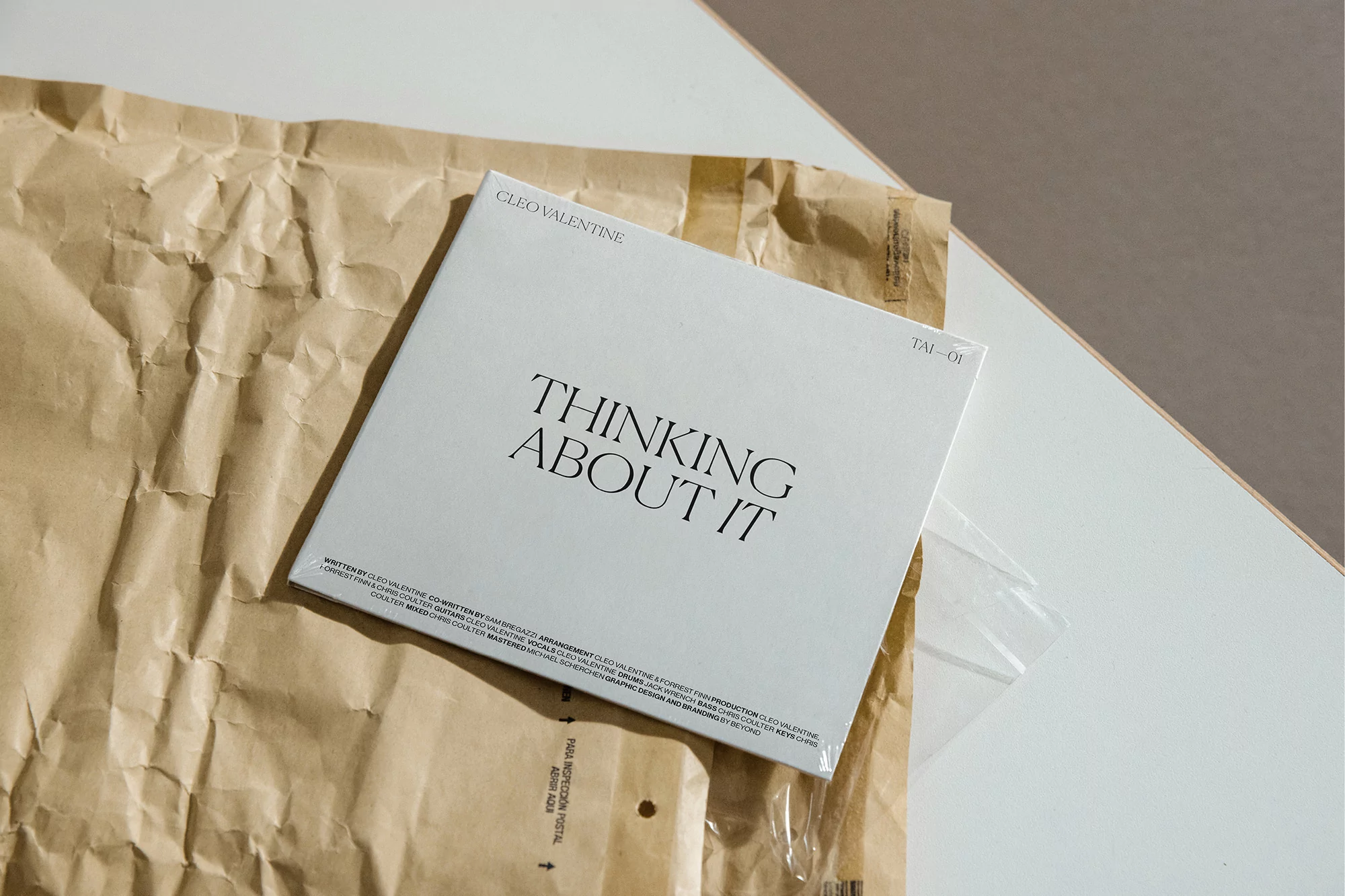 Vinyl record album cover of Cleo Valentine's 'Thinking About It' on a brown paper package against a neutral-tone wall.