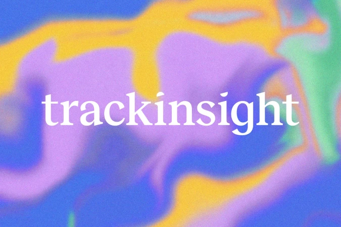 Abstract background with blurred gradients of blue, yellow, green, and purple. White text overlay: 'trackinsight'. Visuals suggest technology.