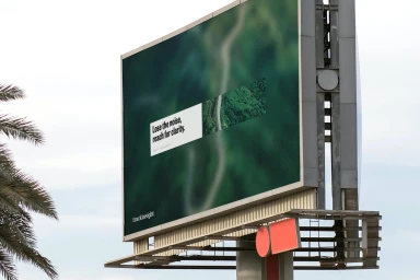 Large outdoor billboard featuring branding for Trackinsight with aerial imagery and text set against a pale sky and palm tree