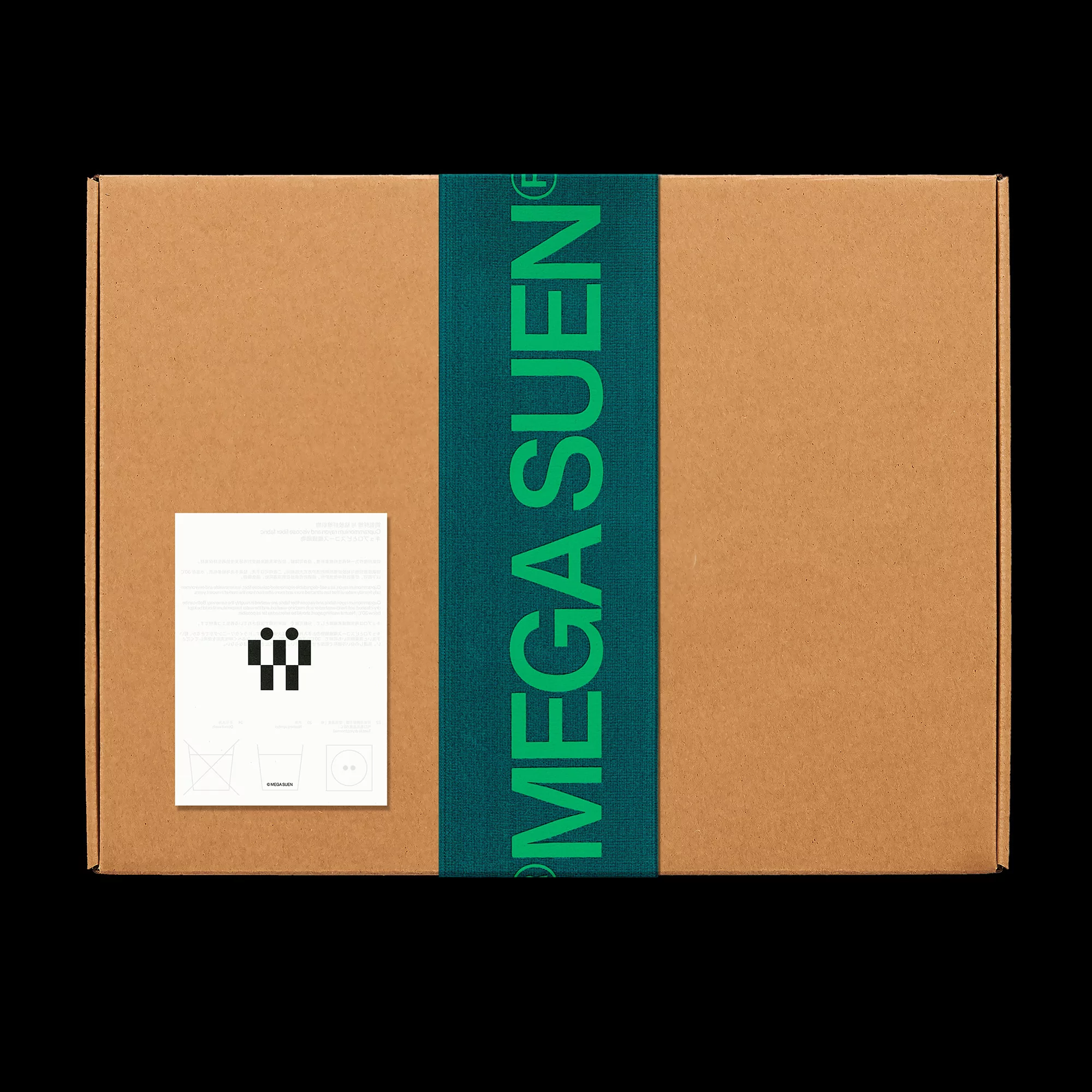 Close-up shot of a cardboard box with a branded green ribbon and a white label, set against a plain black background.