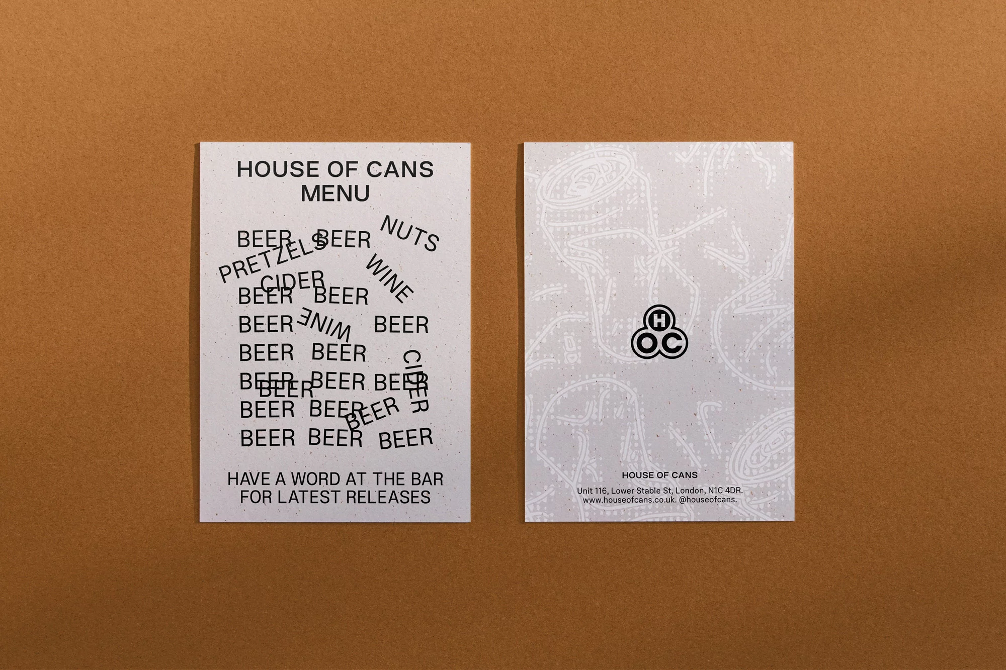 Two white cards with a beer menu, one with a logo, on a brown background showcasing bar and pub advertising design.
