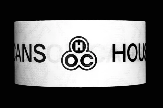 Promotional image with white background featuring black sans-serif text 'CANS & HOUS' and a logo in the center.