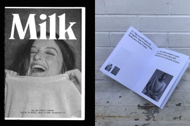 Black and white editorial layout showing a laughing woman holding a textile next to an open booklet featuring printed imagery and text.