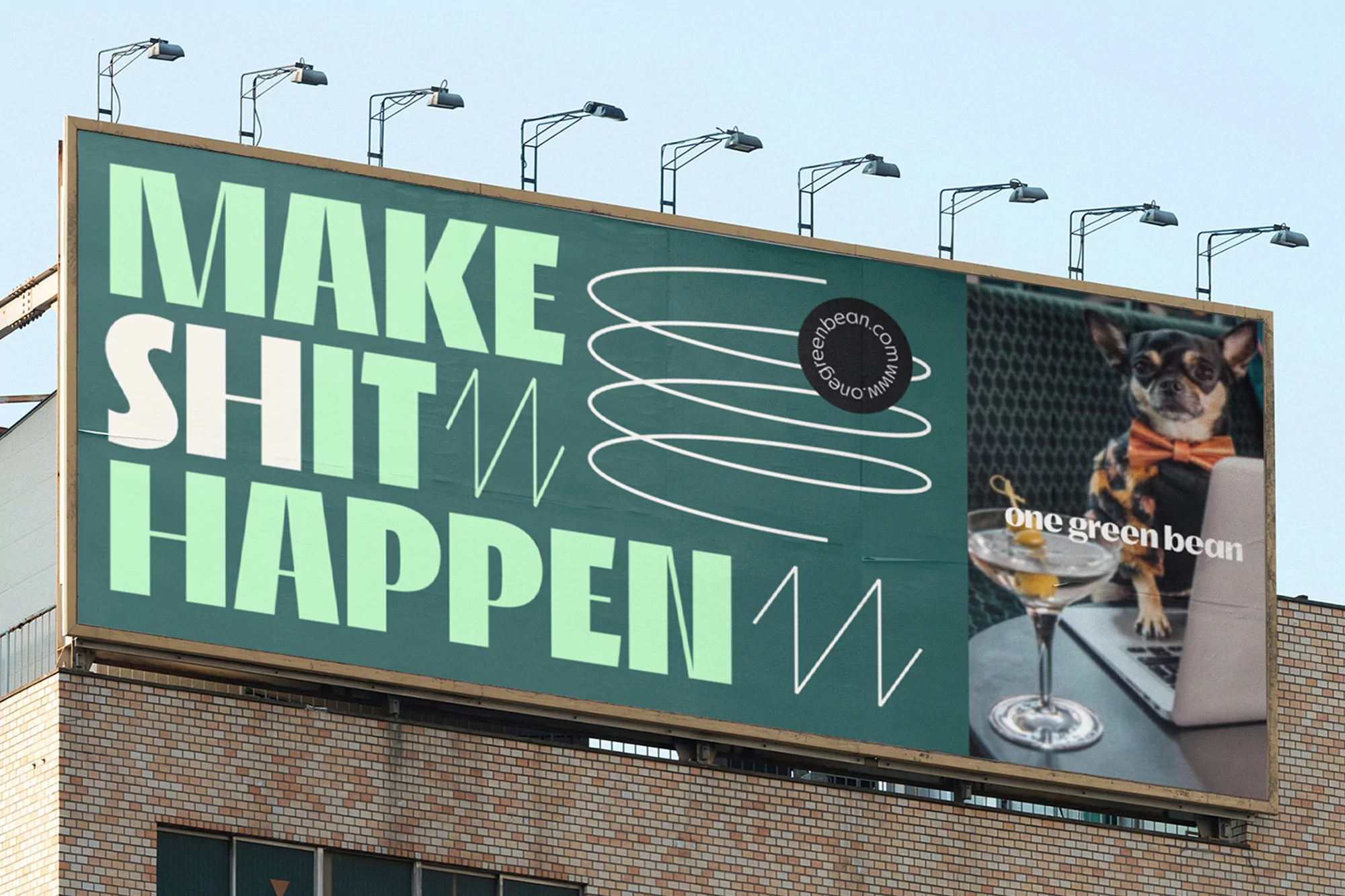 Outdoor billboard showcasing an advertisement featuring a dog wearing an orange bow tie with a martini and laptop.