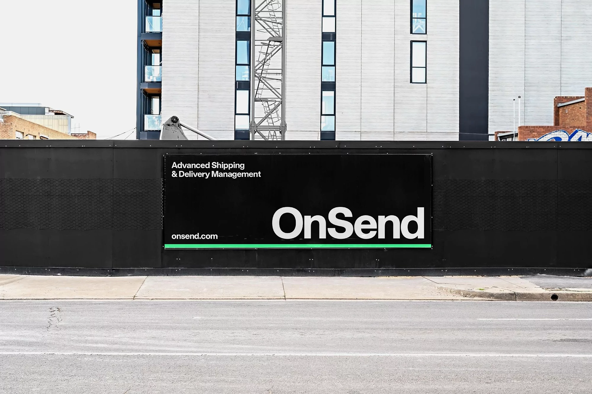 Outdoor shot of a black billboard featuring the text 'Advanced Shipping & Delivery Management' and 'OnSend' in white lettering.