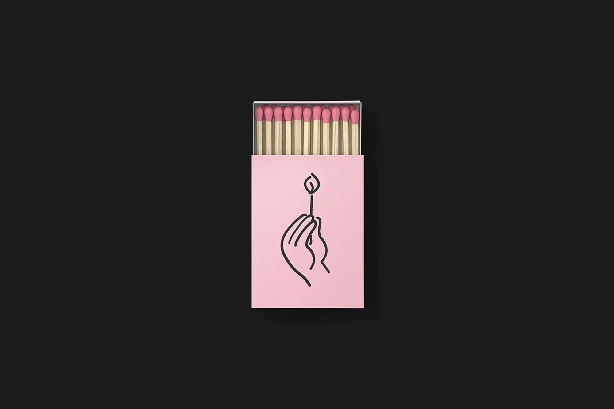 Overhead studio shot of a pink matchbox with black hand illustration, containing wooden matchsticks with pink tips on a black backdrop.