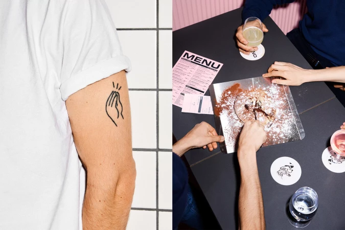 Overhead shot of a table with a dessert being shared by four people, with one person's arm with a tattoo visible.