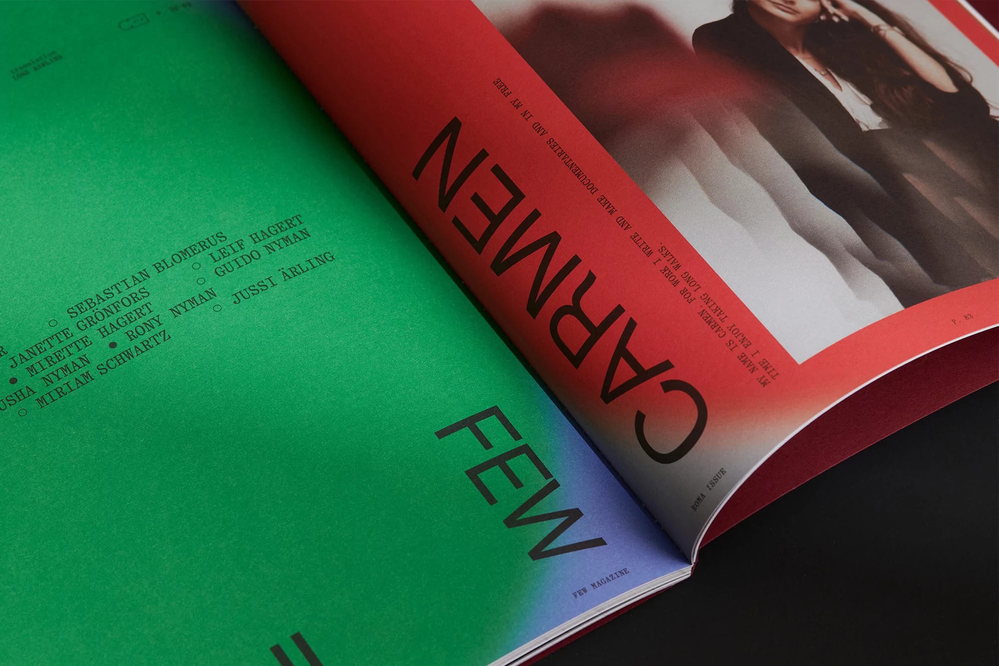 An open magazine spread featuring bold typography on vibrant green and red pages, photographed from an angle.