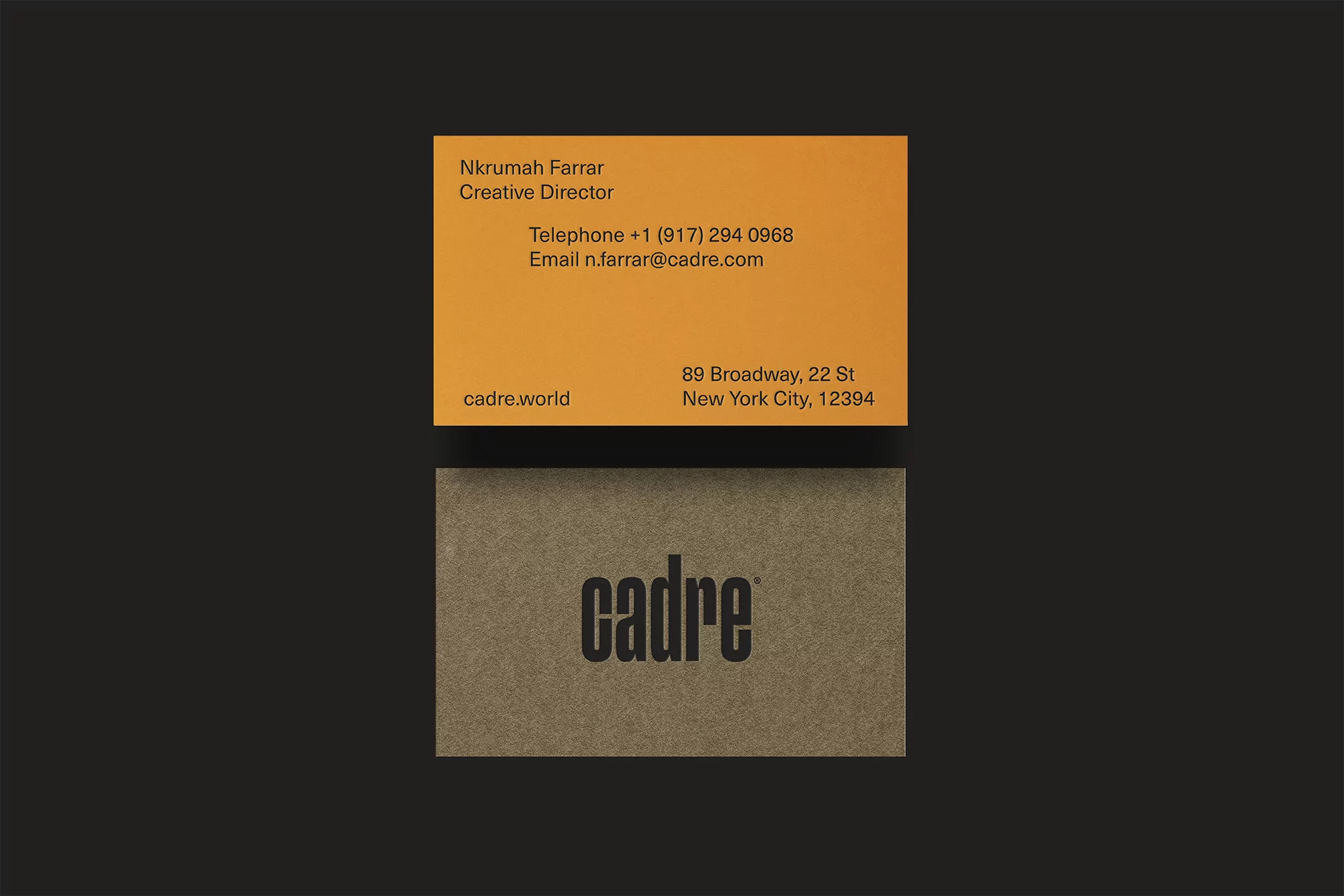 Two business cards arranged on a black background. The top card is orange, while the lower card is light brown with 'cadre' printed.
