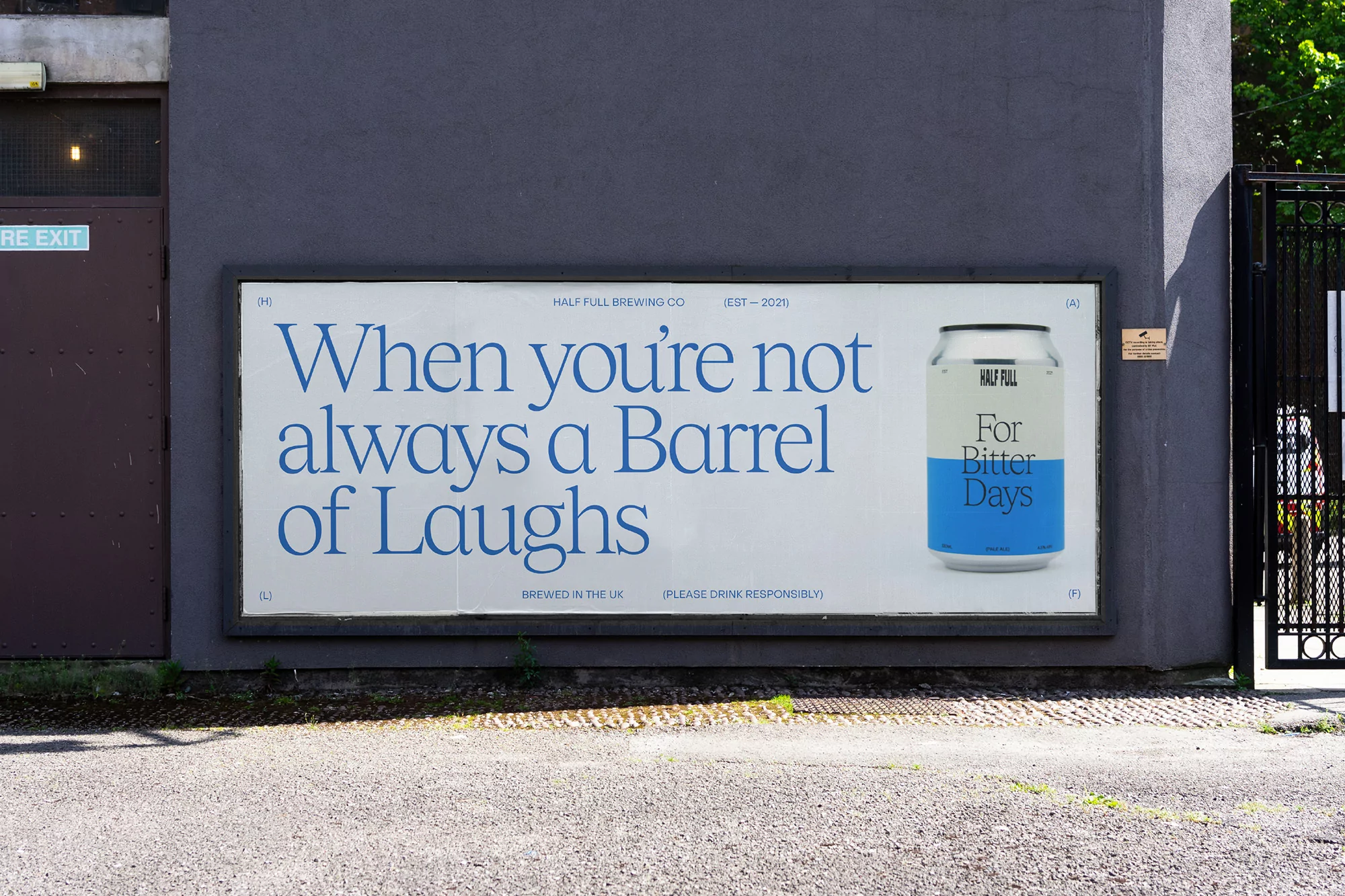 Outdoor advertising for Half Full Brewing Co. features a can of beer against a blue wall with a slogan and brand details.