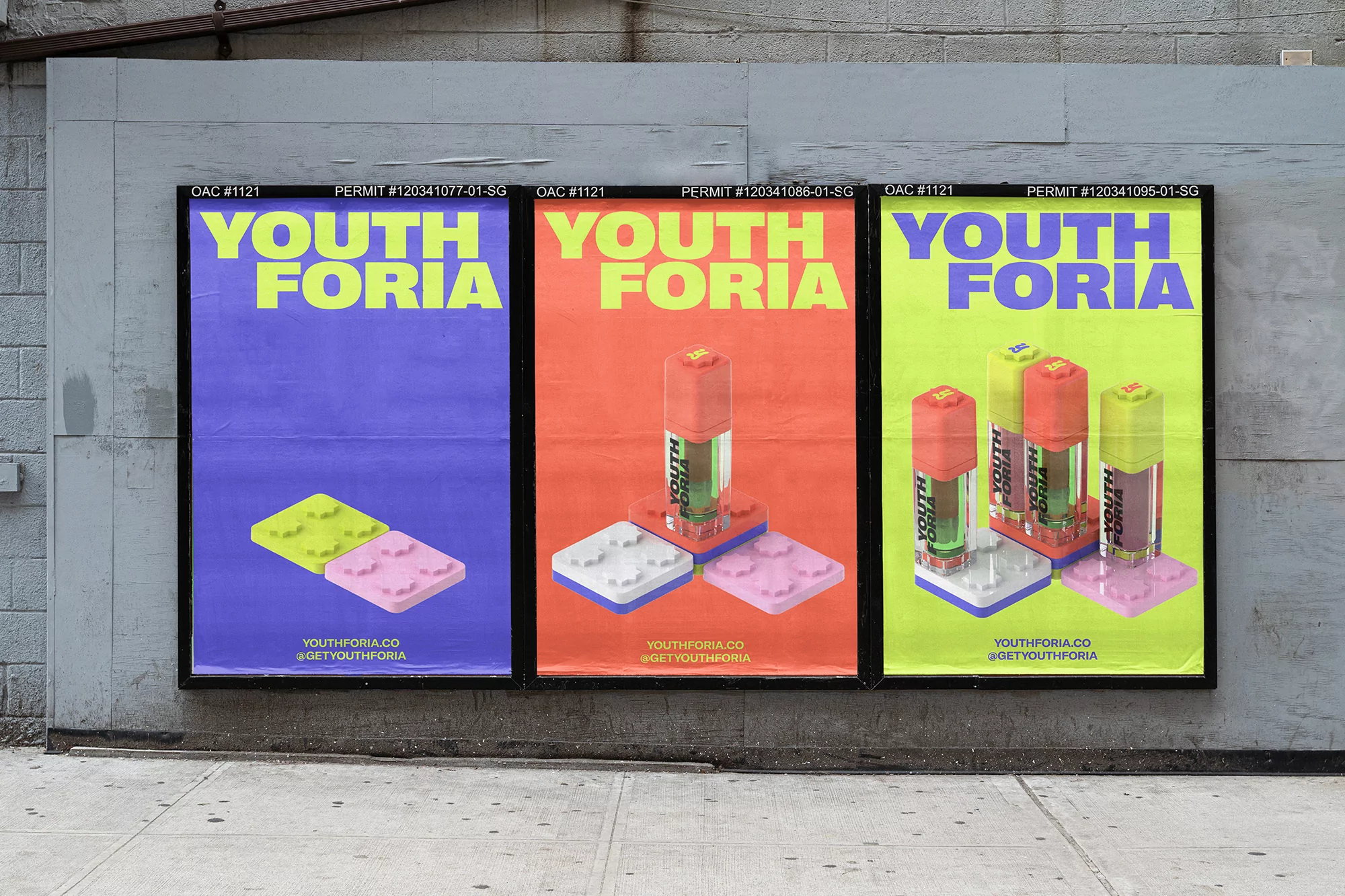 Outdoor shot of three posters advertising 'Youth Foria' on a gray textured wall, featuring bright colors and toy brick art.