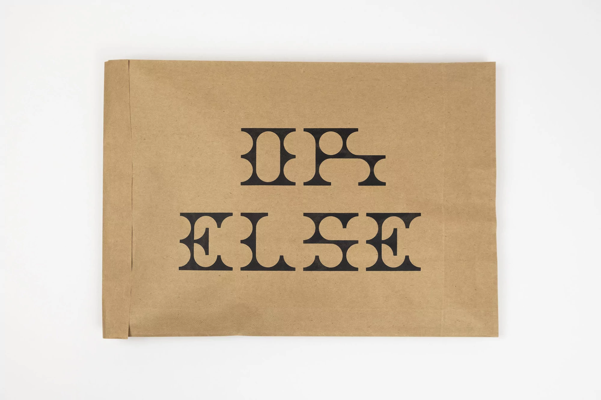 Kraft paper envelope with 'IF ELSE' printed in stylized black font, presented on a clean white background in a studio setting.