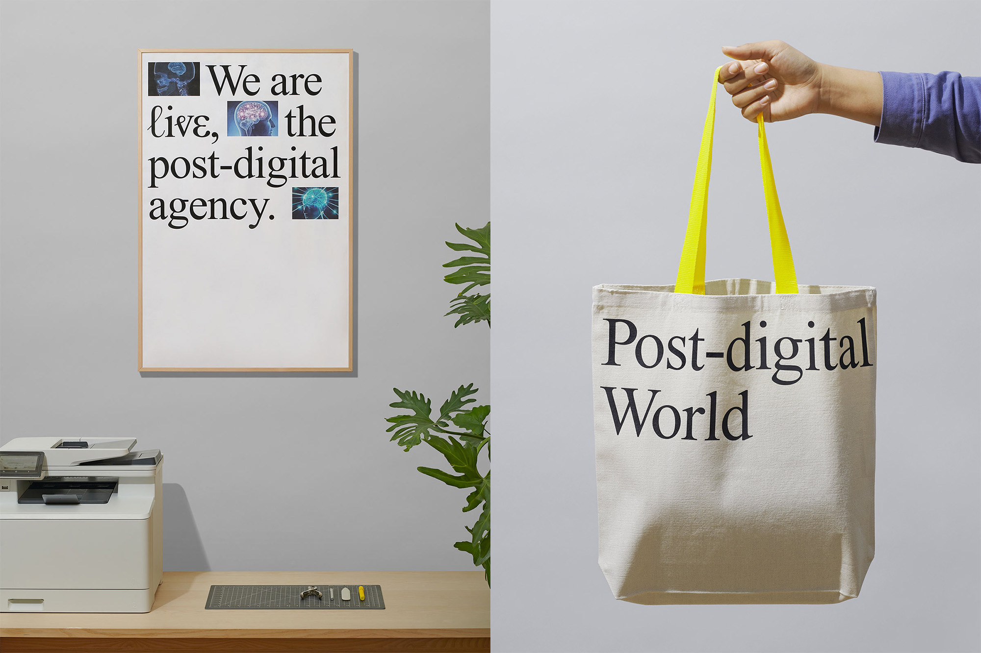 Tote bag with the text "Post-digital World" held by a hand, alongside a framed typographic poster and a small green houseplant.