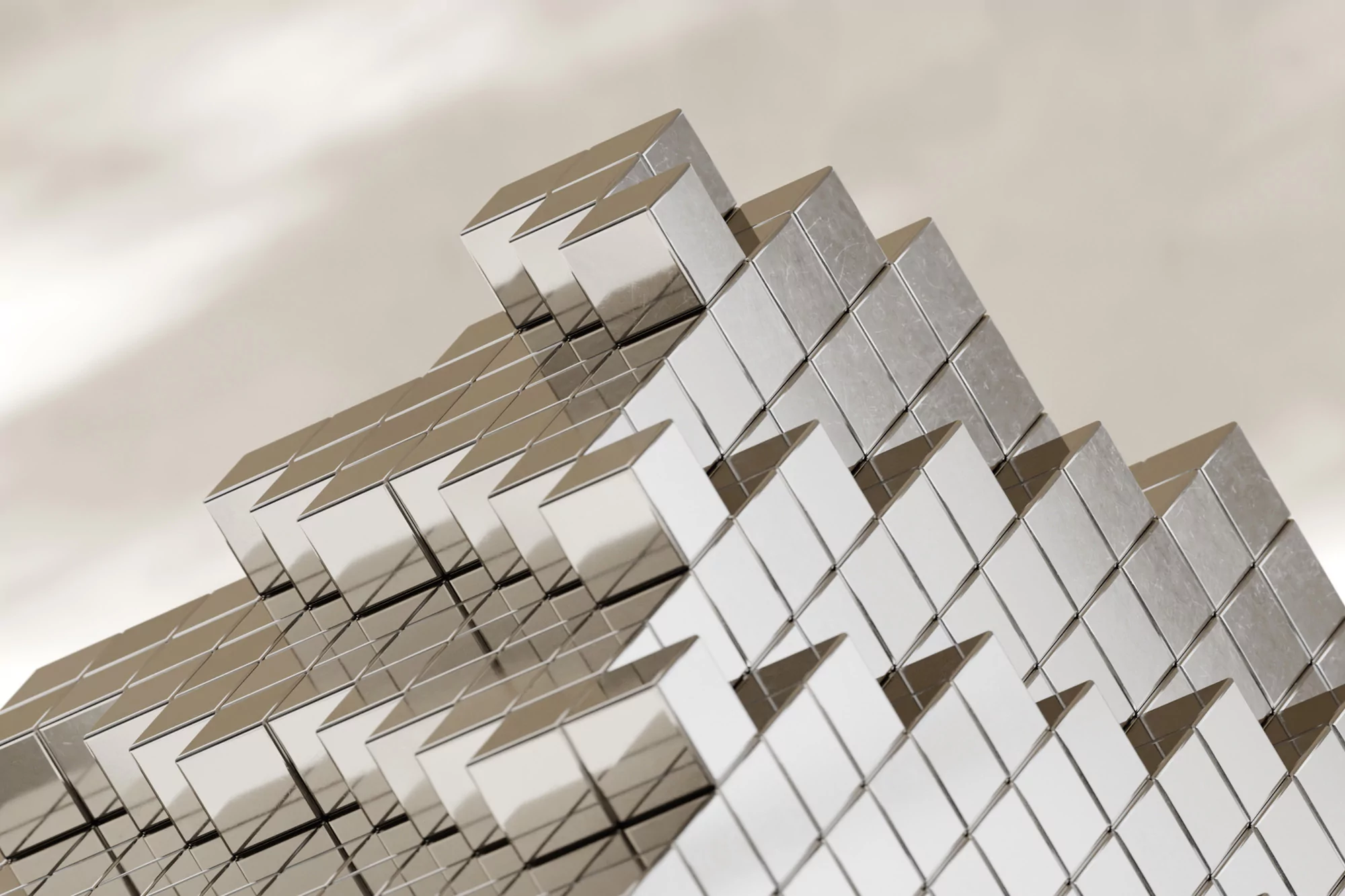 Abstract close-up of a stepped, reflective surface made of small cubes arranged to create a geometric, pyramid-like structure.