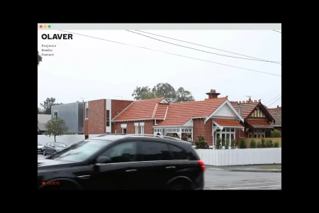 Web interface mockup showcasing OLAVER Architecture brand identity with a red brick residential house and a passing black car.