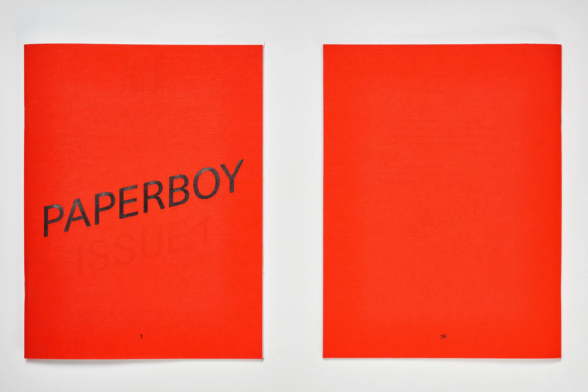 Two red paper pamphlets, one with the title PAPERBOY printed on it. The pamphlet has number 1 at the bottom, the other has number 70.