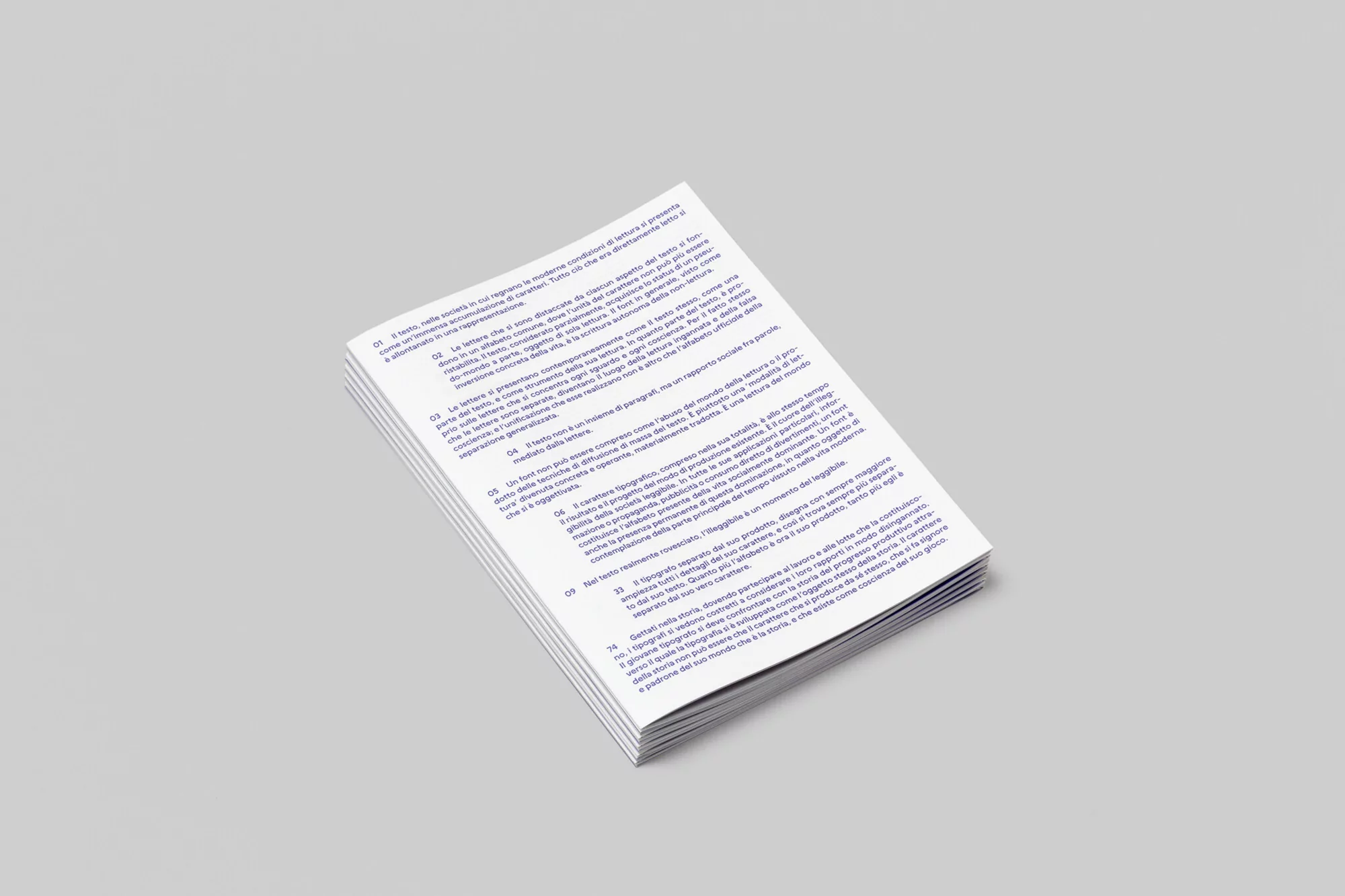 Stack of paper sheets with dense text in a bright, even lighting setup on a neutral background, suitable for print or publication design.
