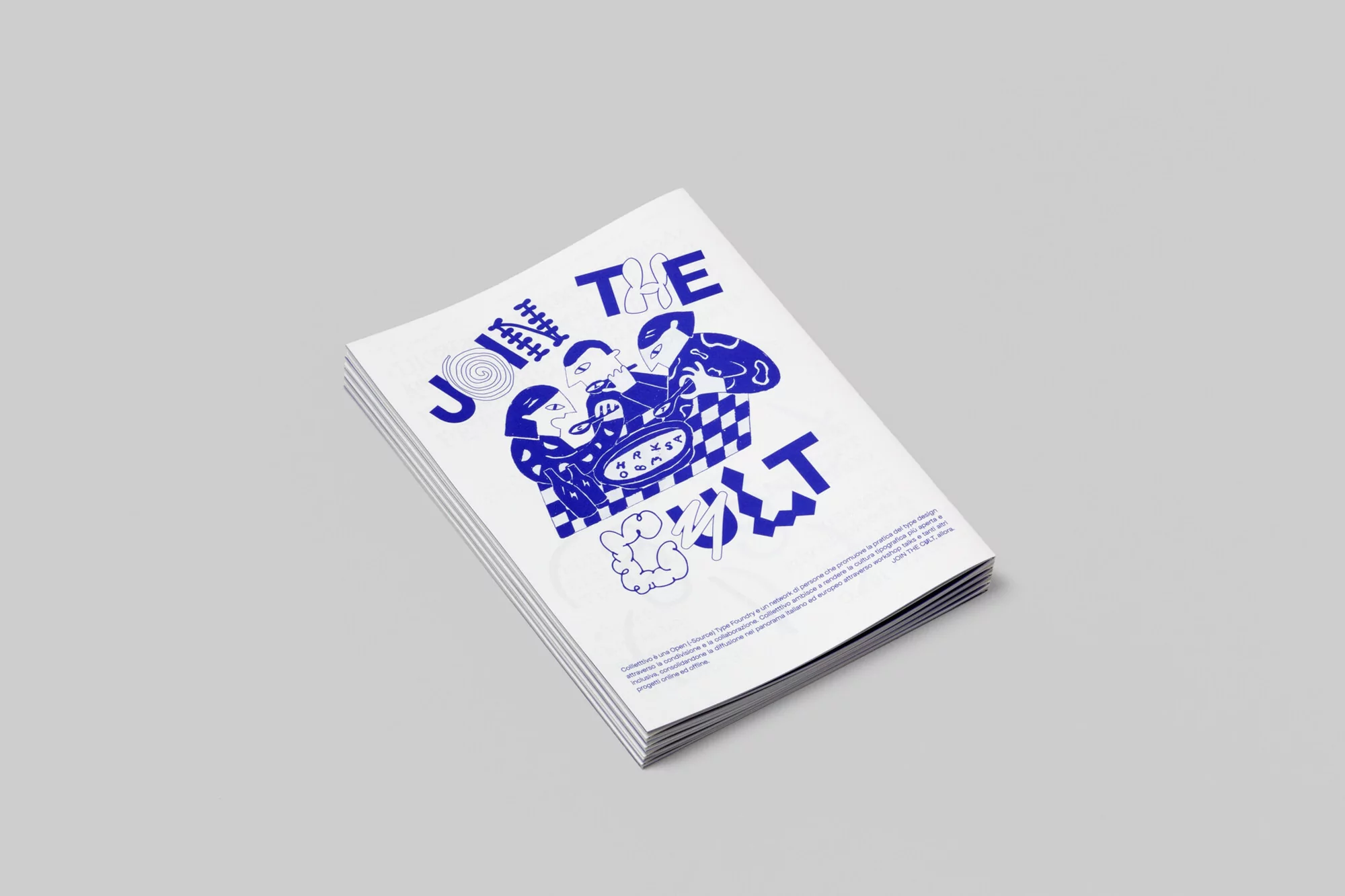 Stack of design magazines with blue graphic illustrations on the white cover, sitting on a grey surface. The cover says, 'Join The Cult'.