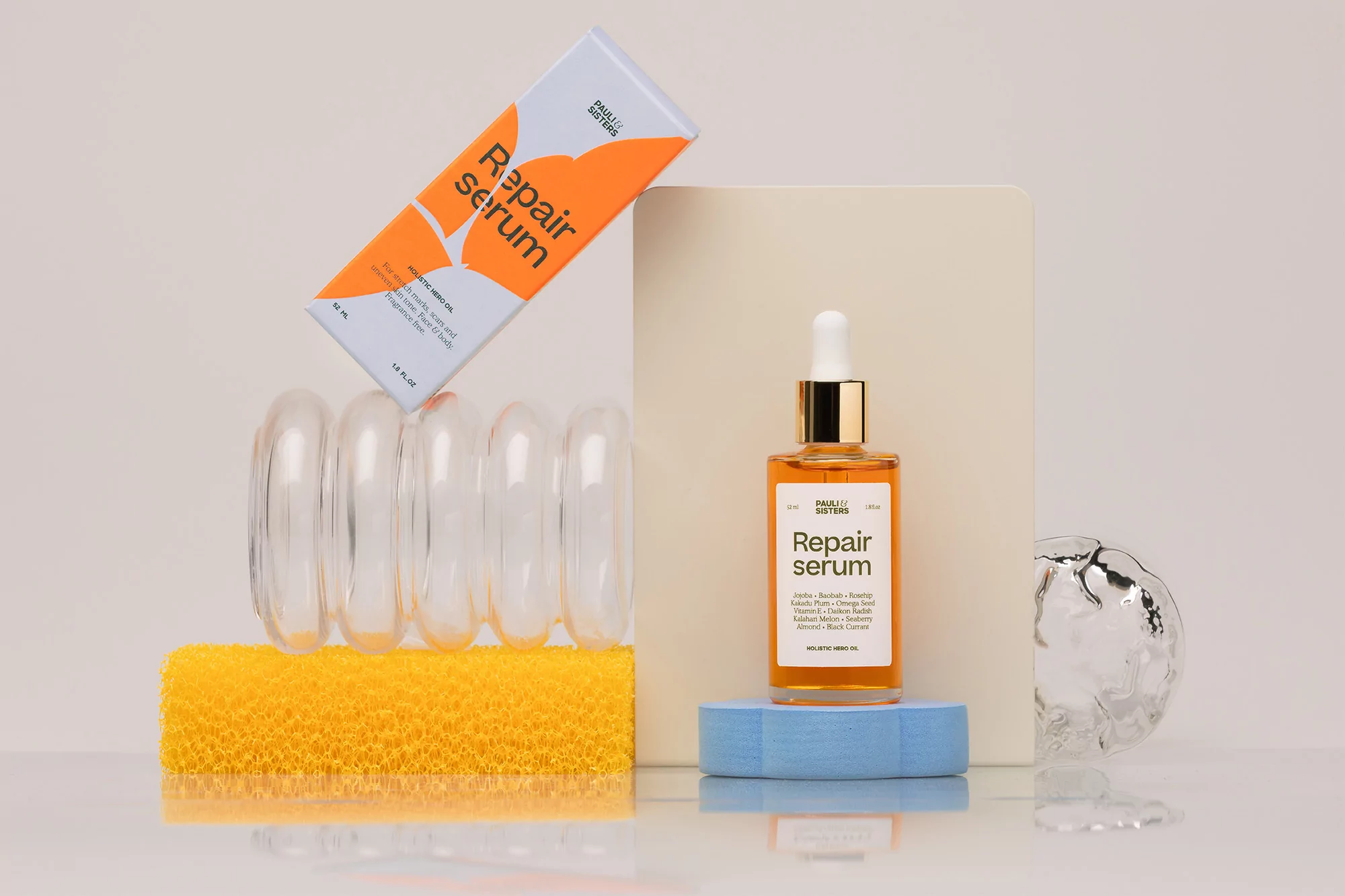 Cosmetic product photography featuring a bottle of facial serum with its packaging box, positioned on a glossy reflective surface.