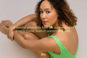 A woman with curly brown hair wearing a green top poses against a neutral background with overlaid text.