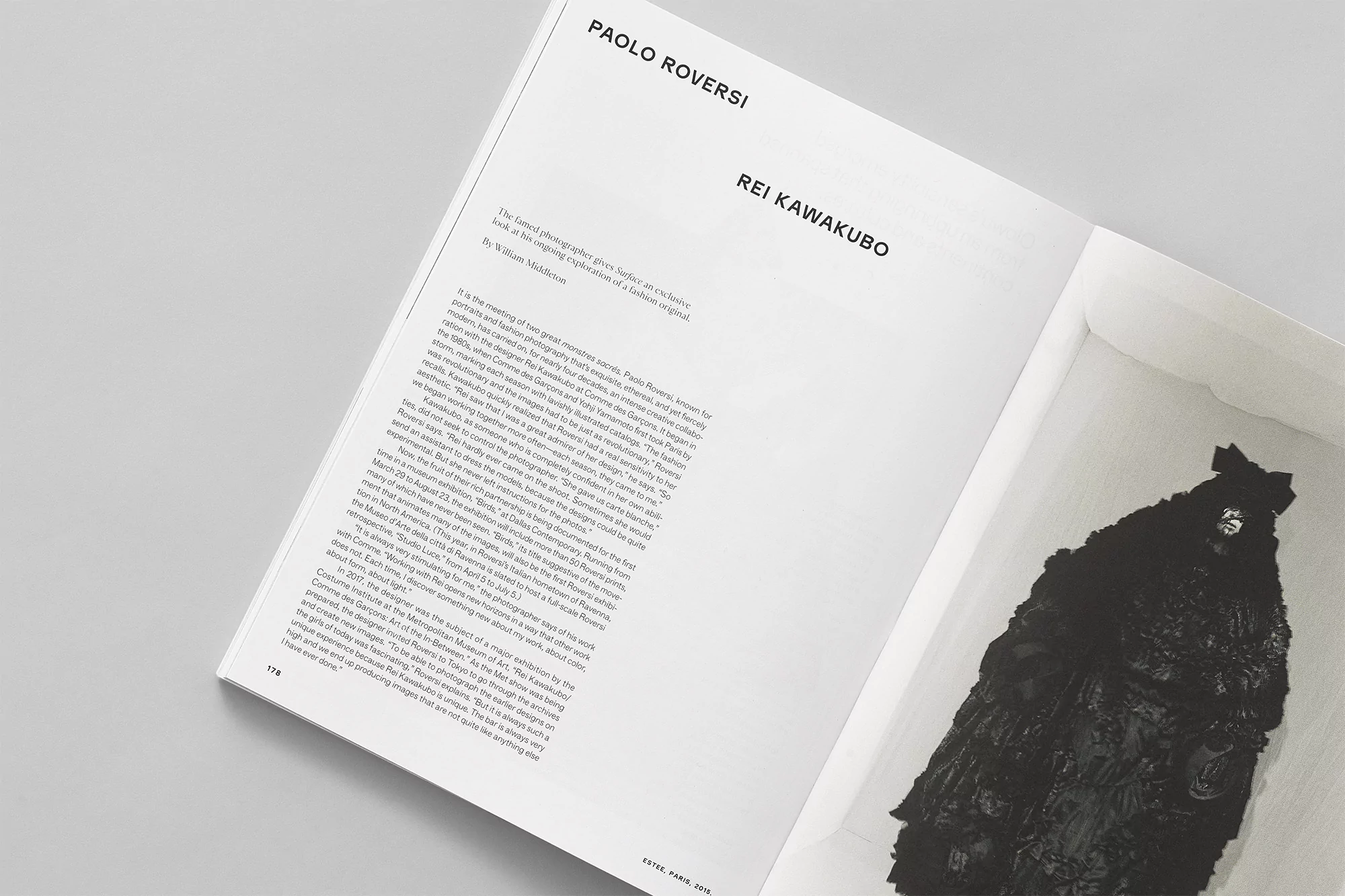 Monochromatic editorial photography of a fashion design by Rei Kawakubo, as seen in a magazine spread.
