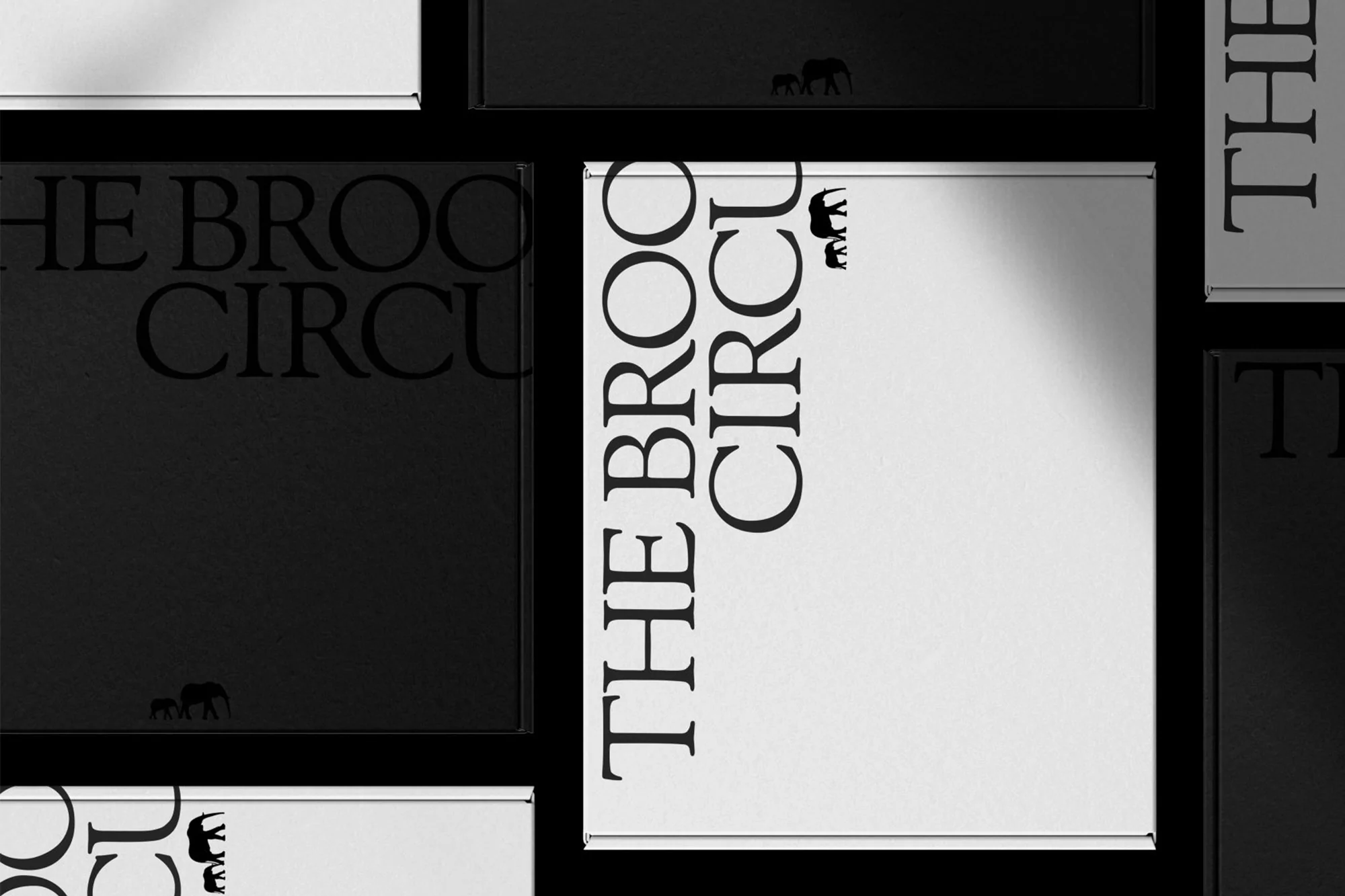 Monochromatic book covers showcase a minimalist aesthetic with bold typography and an elephant logo against a stark black background.