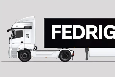 Side view of a white semi-truck with a black trailer featuring large white Fedrigoni branding against a neutral grey studio background