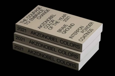 A stack of three beige books with black sans-serif typography against a solid black background.
