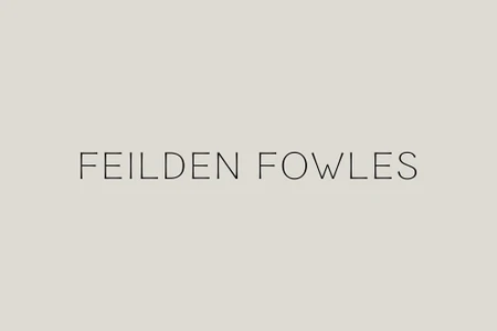 Minimalist graphic brand identity typography displaying Feilden Fowles in thin black uppercase letters centered against a neutral grey background