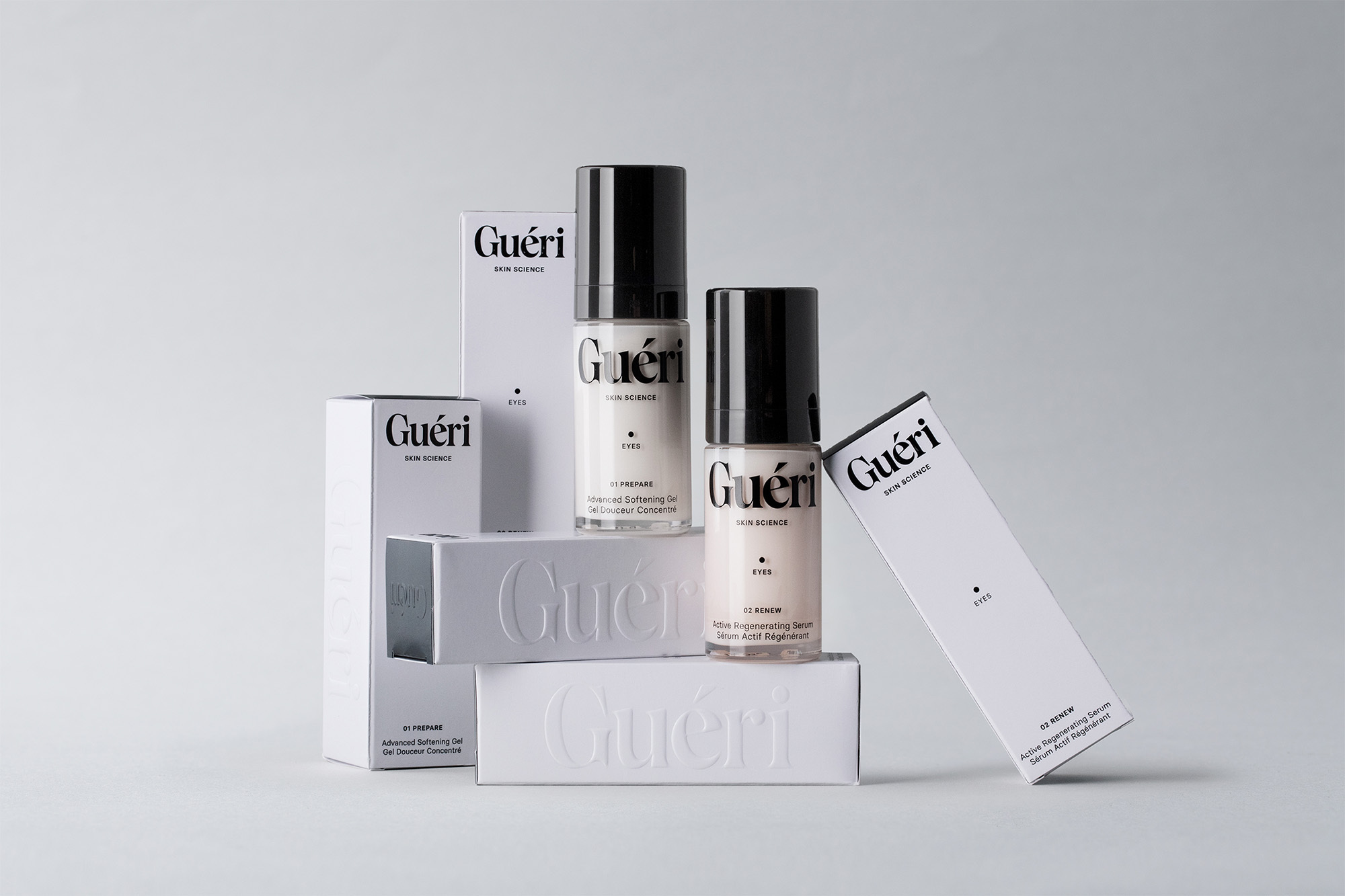 Gueri Skin Science eye serum and gel products in white packaging are displayed in a minimalist product shot against a grey background.