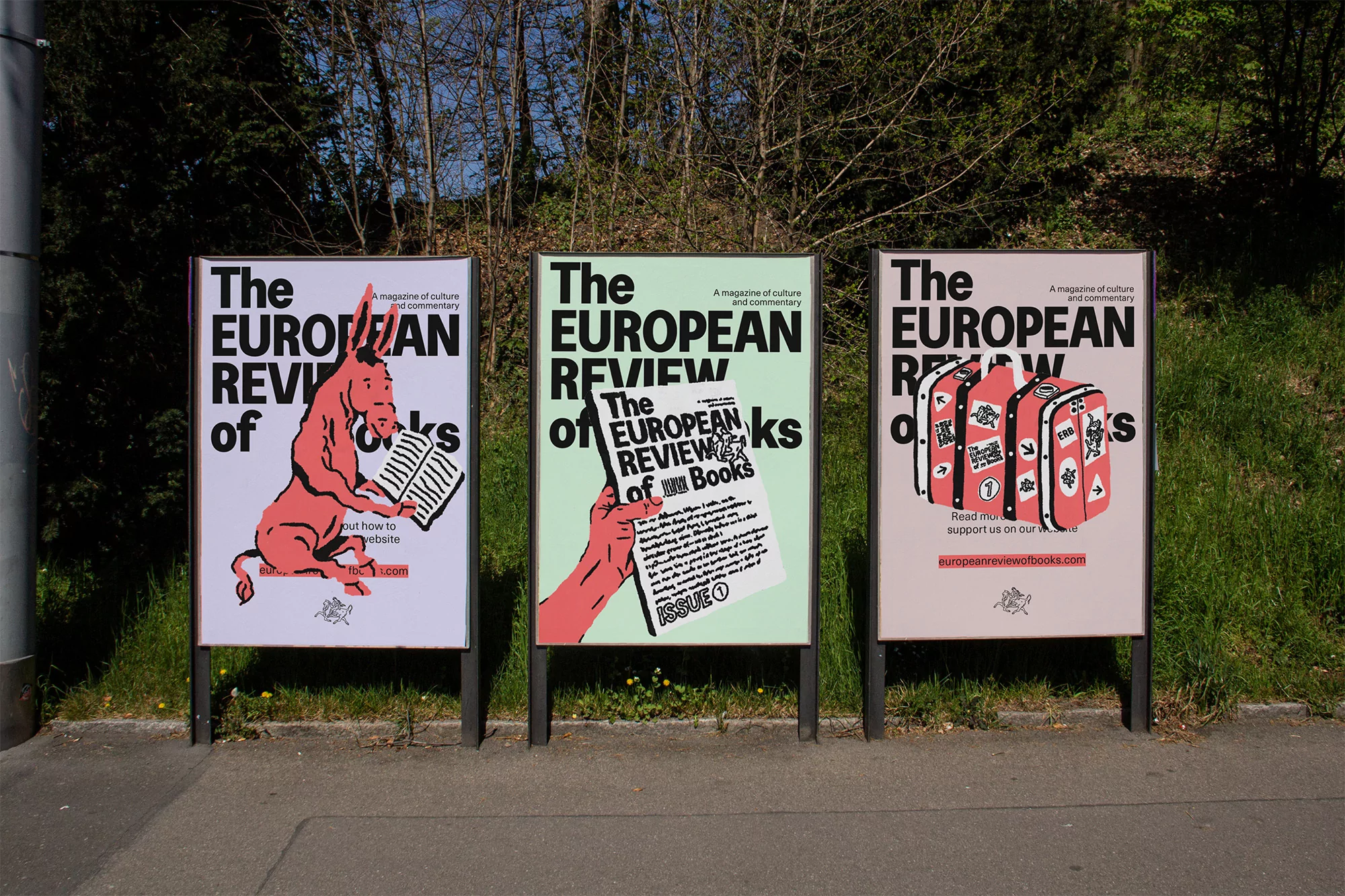 Three posters for The European Review of Books displayed outdoors on a city street. Each poster has a unique illustration in a cartoon style.