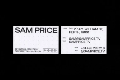 Two white business cards with bold black typography and registration crosshairs against a dark background