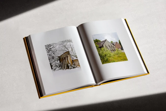 Open book featuring architectural photography in black and white, and color, with a yellow spine and white background.