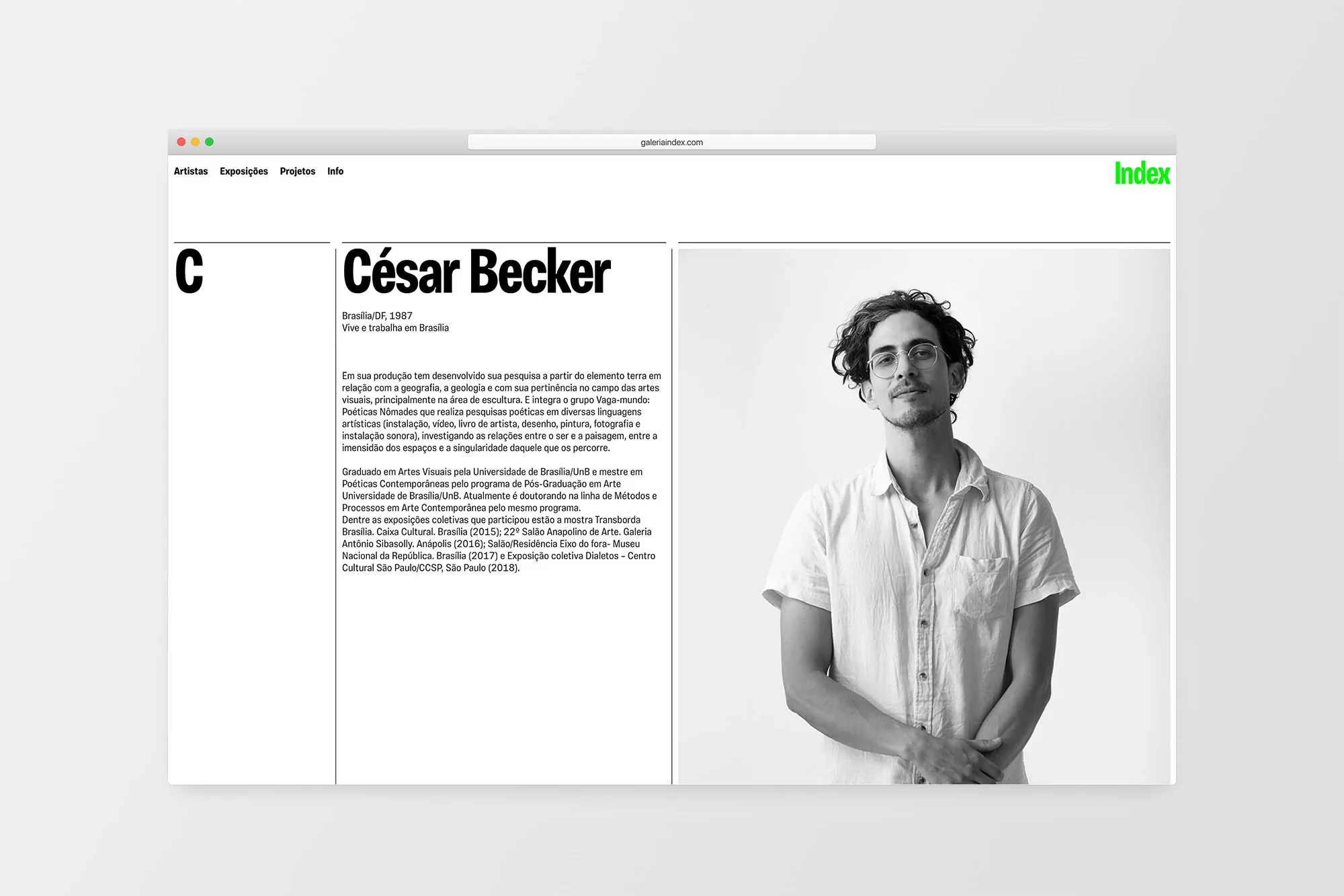 Black and white portrait on a website featuring a man with curly hair, wearing glasses and a button-down shirt, posing indoors.