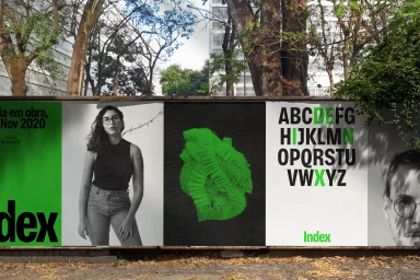 Outdoor billboard display showcasing branding graphics with portraits, typography, and vibrant green accents.