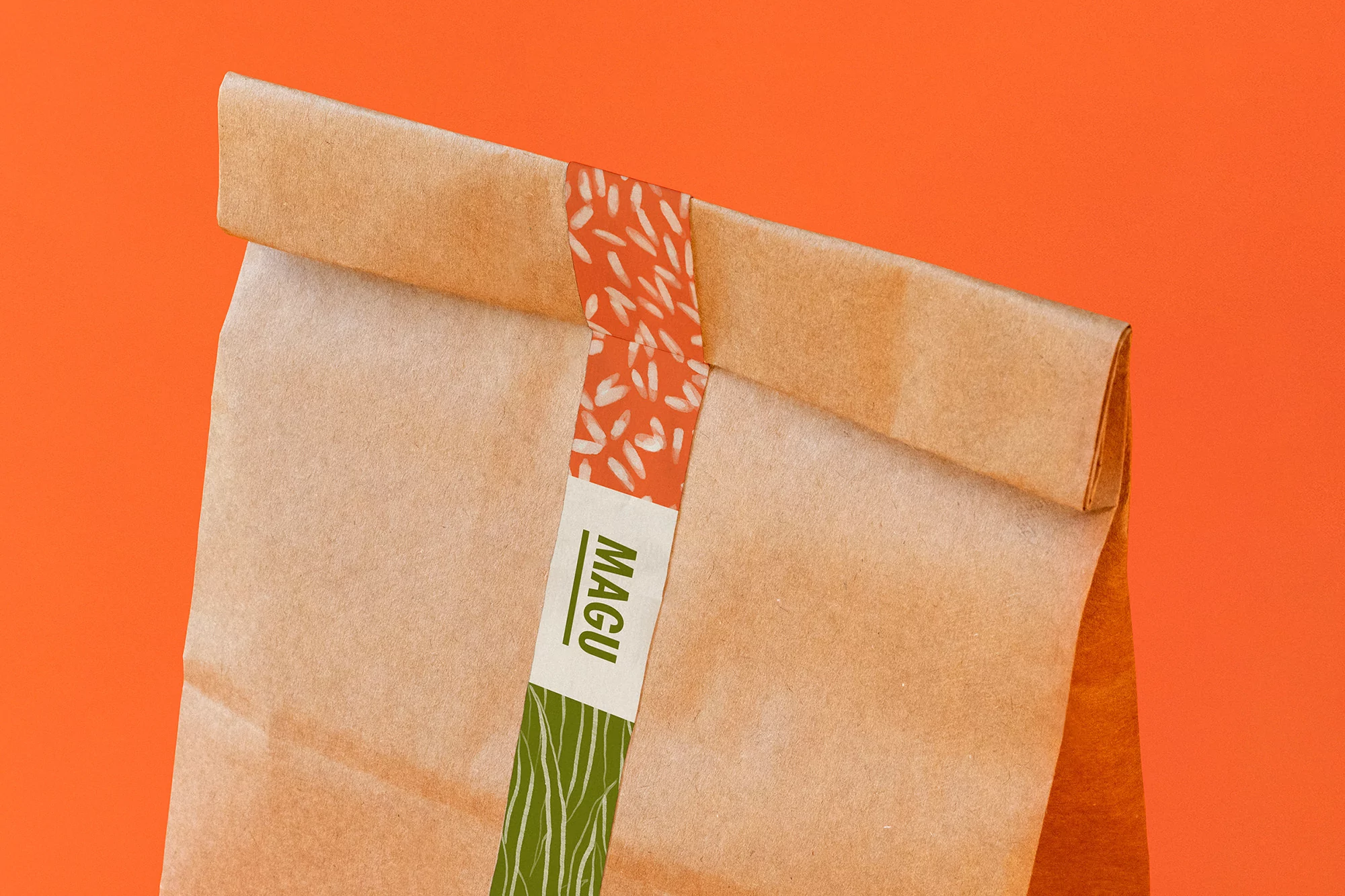 Close-up of a sealed brown paper bag with an orange patterned tape and a green logo on an orange background. Food and beverage.