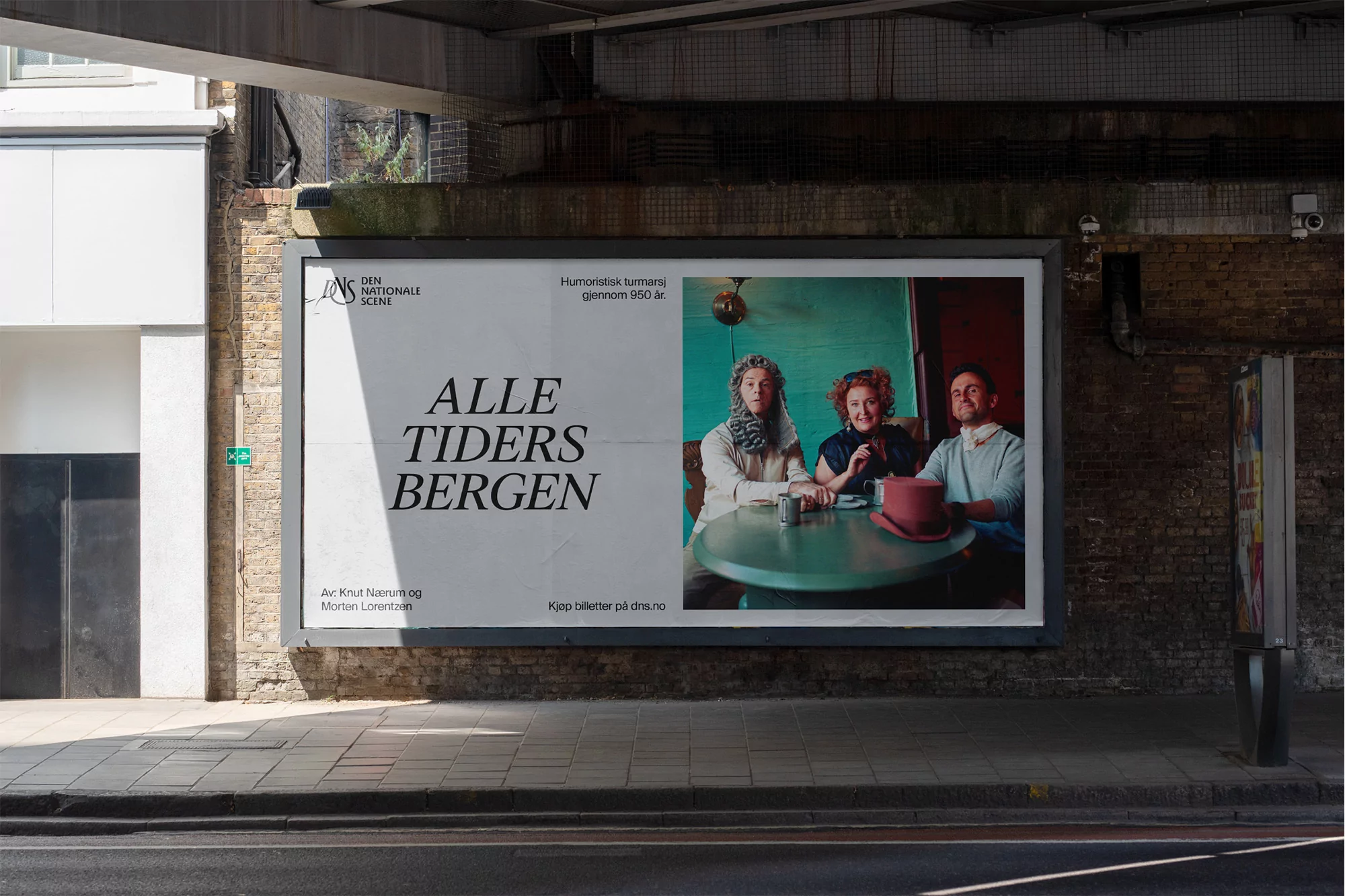 Outdoor billboard showcasing an advertisement with three people at a table and bold text for 'Alle Tiders Bergen'.