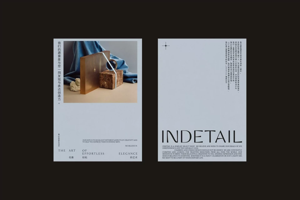 Conceptual still life of geometric objects with graphic design posters against a dark background, using amber, beige, and blue tones.