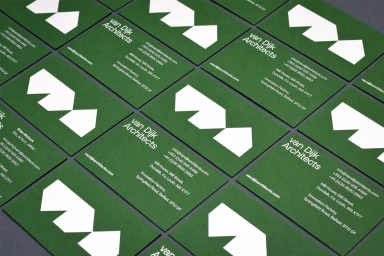 Multiple green business cards with white typography and geometric house logos laid out neatly in a grid.